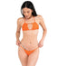 A woman wearing an orange bikini top with a deep neckline and backless design, standing against a white background.